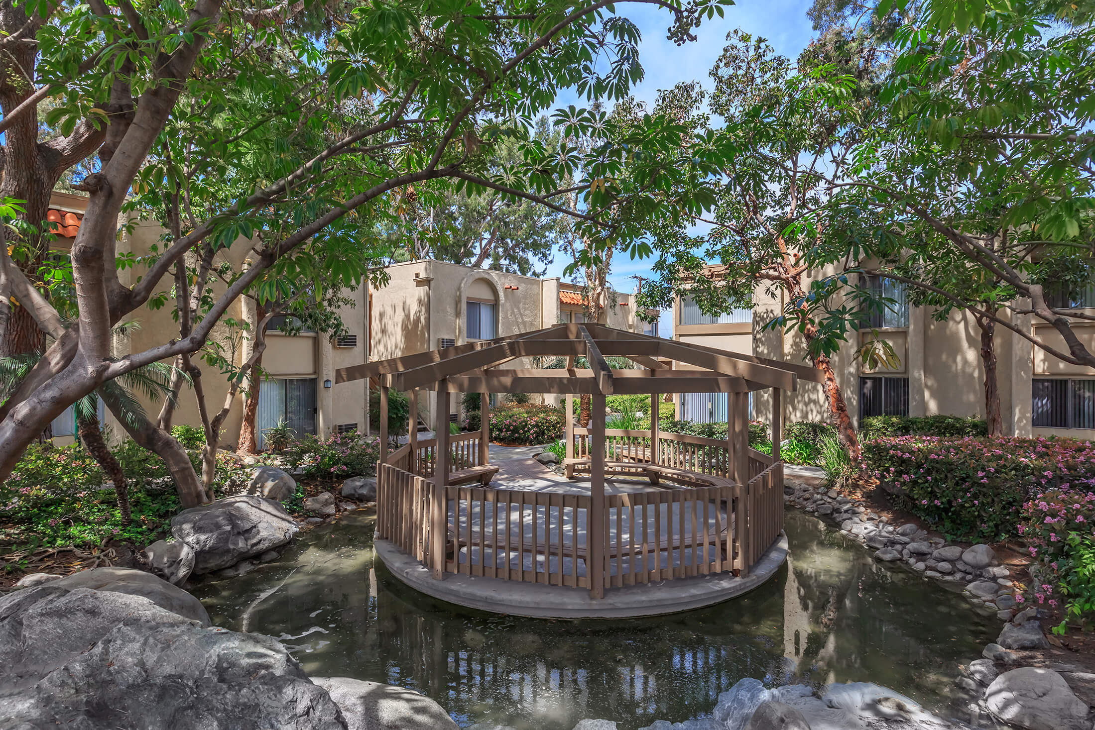 Gazebo seating area near a small pond